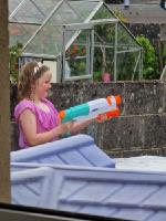 Young girl having waterfight