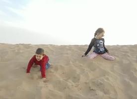 Boy and girl in the sand at desert (1)
