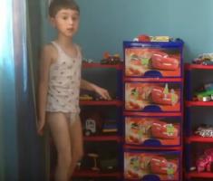 Boy in undie playing toys tanks