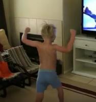 Two boys dances in front of the tv