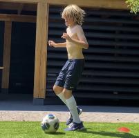 Young pretty blonde soccerboy with long legs
