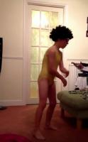 Boy wearing a swimsuit of girl and dances