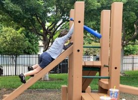 Kid boy wearing dark blue short pant in playground 6