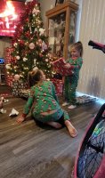 Girl in green pajama with her little sister x-mas