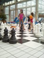 Boys and girls playing chess in a water park