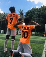 Boys playing football in Orange